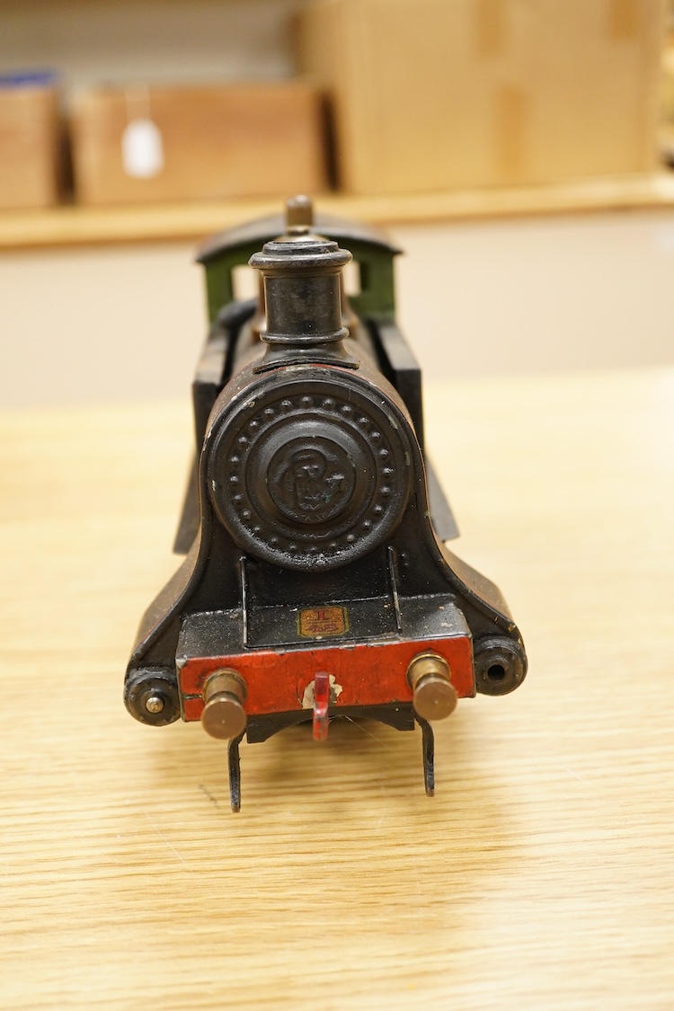 An early 20th century Gauge One Bing live steam 0-4-0T ‘I48’ locomotive, with a spirit fired pot boiler, driving a single oscillating vertical cylinder mounted in the cab, with twin outside dummy cylinders, the regulator